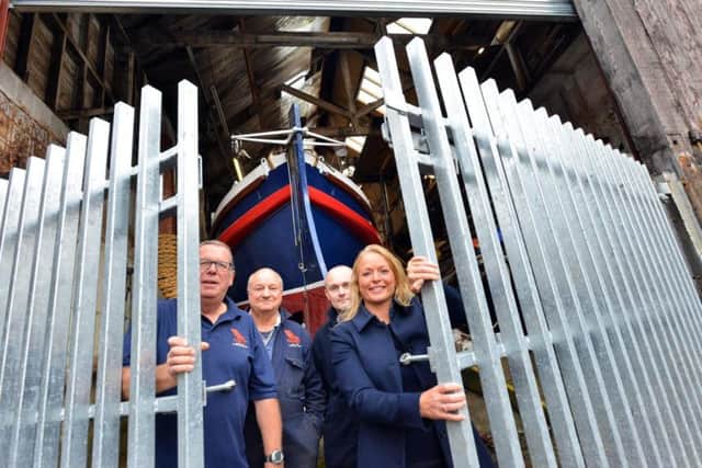 New shutters and gate at The North East Maritime Trust donated by Solar Solve Marine. From left Trust's secretary Jerry Dubman and Dave Parker with Solar Solve Ian Ratcliffe and MD Julie Lightfoot MBE