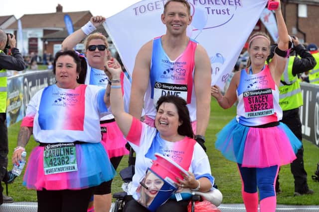 The Chloe and Liam Together Forever Trust team, led by parents Caroline Curry, left, and Lisa Rutherford, cross the finish line of the Great North Run 2018.