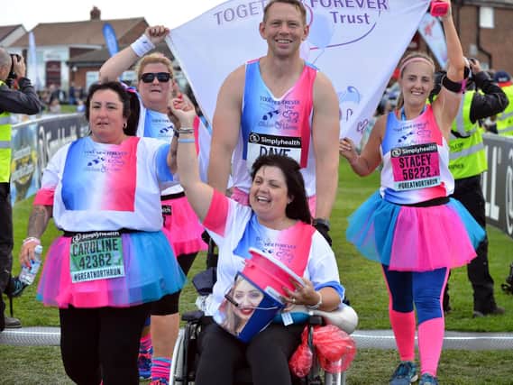 The Chloe and Liam Together Forever Trust team, led by parents Caroline Curry, left, and Lisa Rutherford, cross the finish line of the Great North Run 2018.