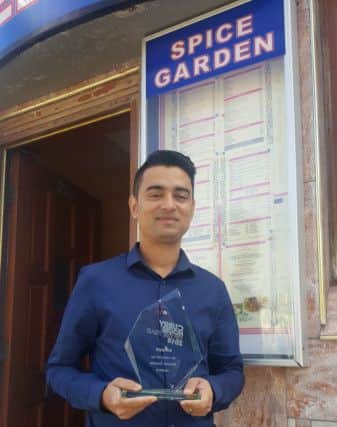 Spice Garden manager Rukon Chowdhury with his Curry House of the Year award.