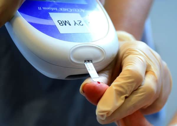 A nurse giving a patient a diabetes test. Picture by PA Wire/PA Images