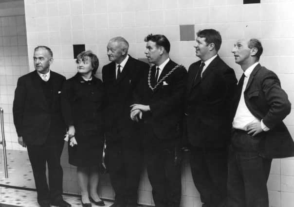Mayor of Jarrow, Councillor F P Dixon with Councillor Mrs M Stewart, chairman of Jarrow Baths Committe, showing a party of Warrington Town Council members and officials around the Walter Street baths. 1969.