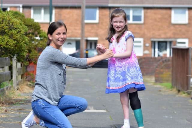 Imogen Carr, pictured with mum Jeni, taking some of her first steps before her latest surgery.