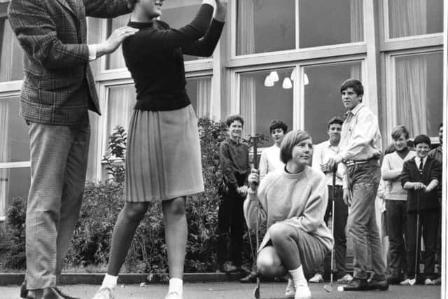Heather Hogg, pupil from Brinkburn County Secondary School, receiving instruction from Shields golf professional Howard Spencer. while Janice Wilson, David Millett and other members of the golfing glass watch. The date is  October 1967.