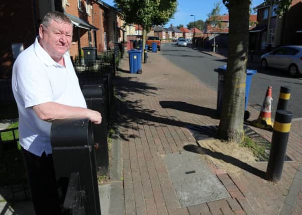 Ron Smith is livid about tree roots which have caused chaos to a phone box and pavement on Mulberry Crescent, South Shields.
His grandson injured his head after falling. Picture by Tom Banks
