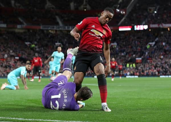 Martin Dubravka saves from Anthony Martial.