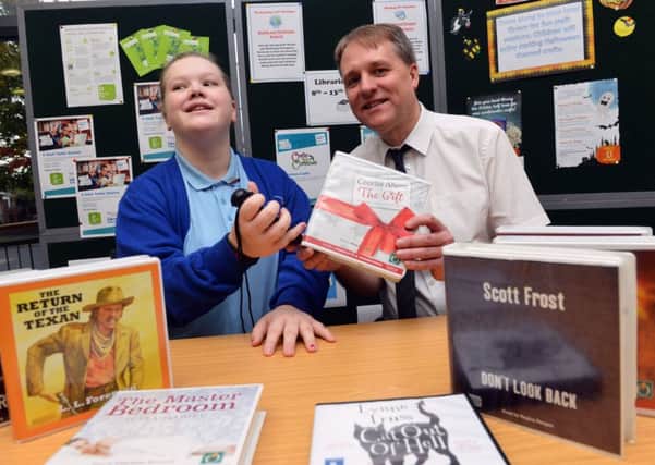 Abbie Blakey with the Penfriend to help people with sight problems.With Librarian Tom Relph