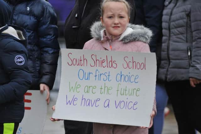 Parents and children took to the town centre to protest the school's closure.