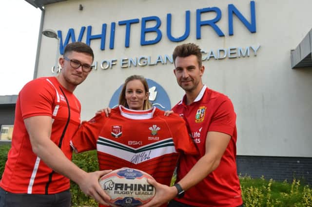 Former Whitburn C of E Academy pupil and Wales rugby player James McGurk donates his signed shirt to head of year Charlotte Rush and head of PE James Leggett (R)