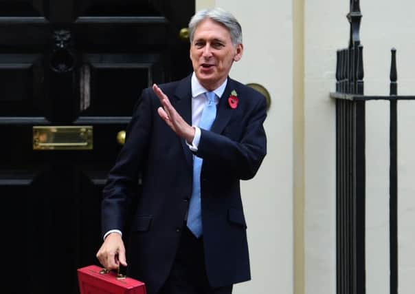 Chancellor Philip Hammond holding his red ministerial box outside 11 Downing Street, London, before heading to the House of Commons to deliver his Budget. Picture by: David Mirzoeff/PA Wire