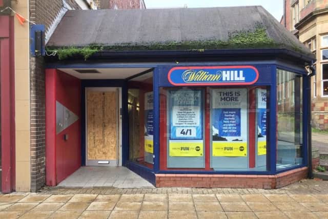 The door outside William Hill has been boarded up today