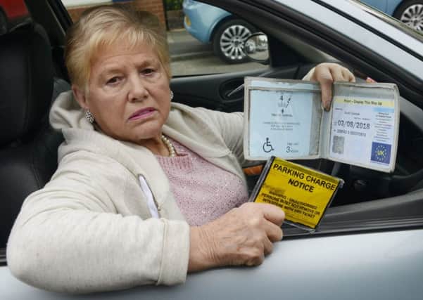 Mary Thompson with her parking ticket and blue badge.
Picture by Jane Coltman