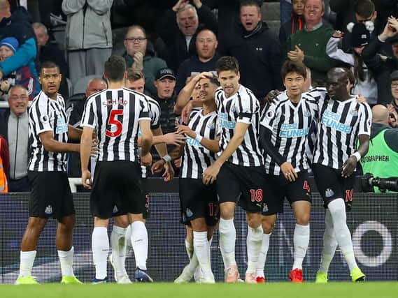 Ayoze Perez, centre, is mobbed by his team-mates.