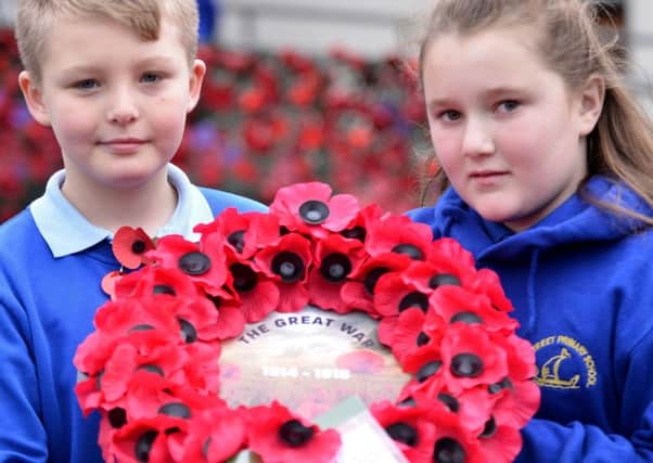Dunn Street Primary school pupils Lucas McDonald and Alisha Hawthorn holding a Poppy Wreath made by pupils. Poppy Display Picture by FRANK REID