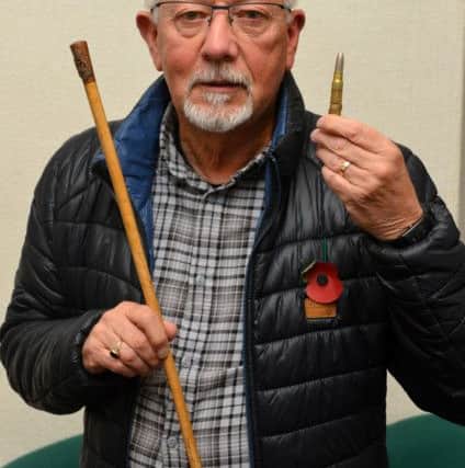 Thomas Barlow with his great uncle Thomas Bolton Foster Prime's WW1 swagger stick and bullet