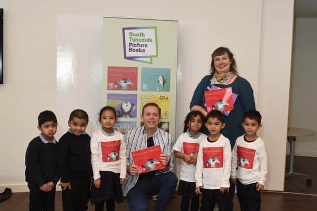Chris Jarvis and artist Alizon Bennet with pupils from Hadrian Primary School with their book
