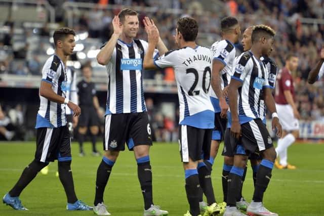 Mike Williamson celebrates scoring his only Newcastle goal with Florian Thauvin.
