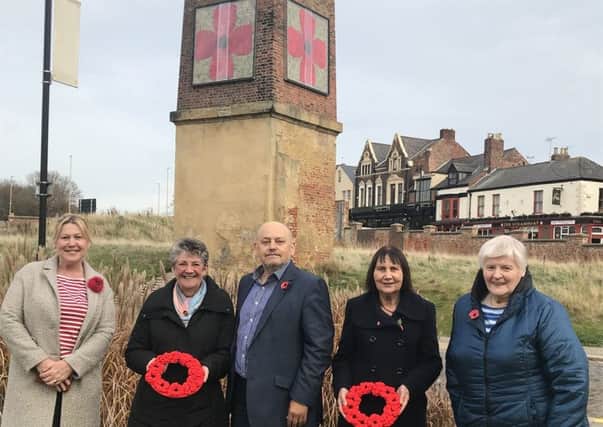Ray Spencer MBE, executive director of The Customs House (centre) with members of The Materialistics (l-r) Mary Wilson, Jenny Hunt, Jean Thornton and Margaret East, next to the framed poppies.
