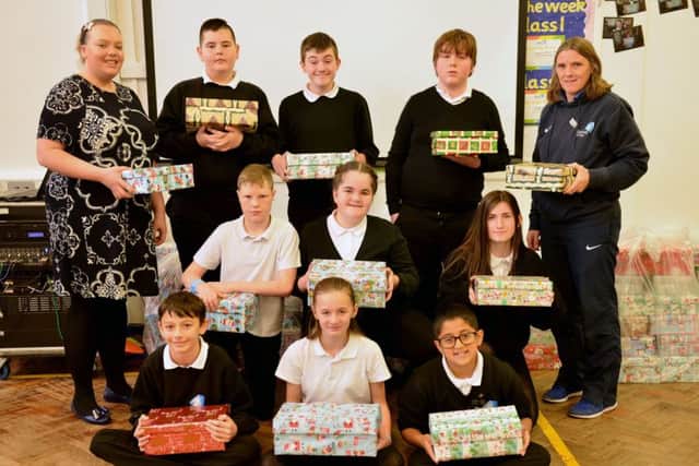 Epinay School classroom support Sarah Vincent (rear left) and teacher Ann Walsh (rear right) with pupils and their shoe boxes.