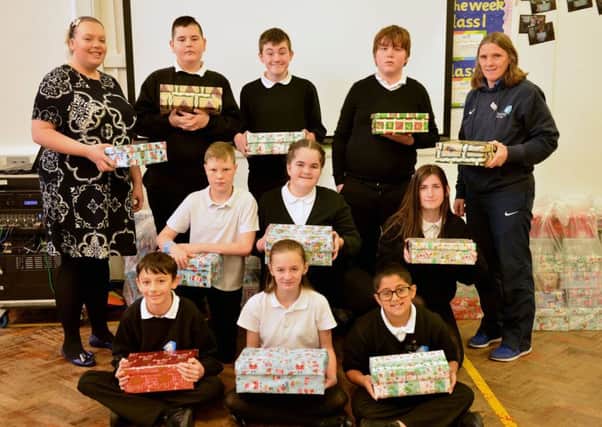 Epinay School classroom support Sarah Vincent (rear left) and teacher Ann Walsh (rear right) with pupils and their shoe boxes.