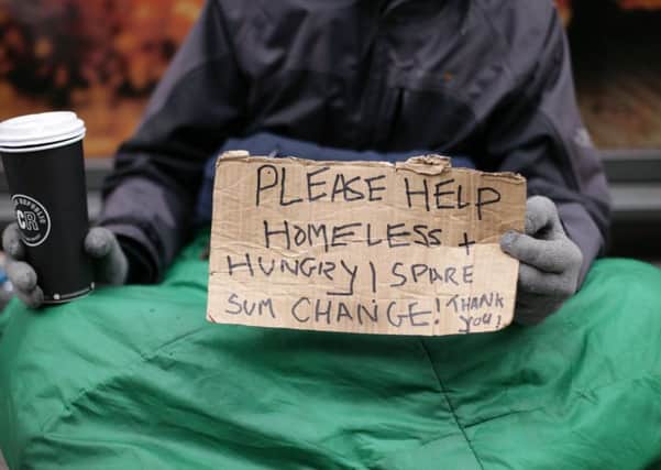 A homeless person seeking money.  Pic: PA Wire.