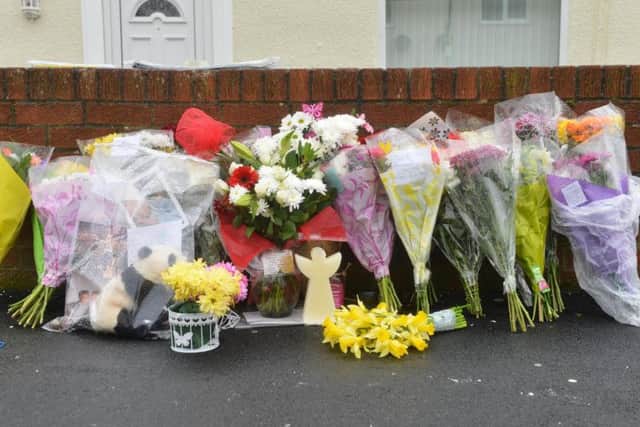 Floral tributes to James Carlo Wilson.