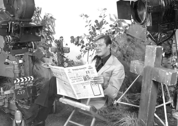 Actor Roger Moore, the new James Bond, reading the Gazette during a break in filming the latest film, Live and Let Die in 1973.