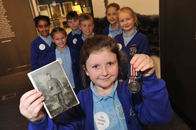 Saints Peter and Paul RC Primary School pupil Lexi Cairns with her Great Great Great Grandfather Private John Legg's Military Medal, at South Shields Museum and Art Gallery.