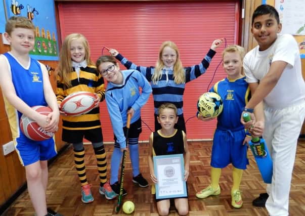 Youngsters celebrate their school being awarded a Platinum Sports Award