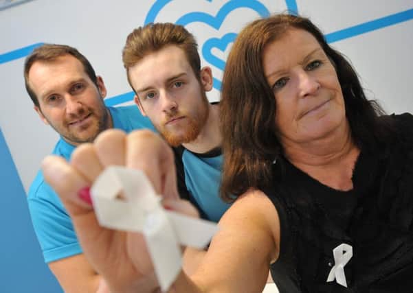 Impact Family Service's Julie Robinson with Gym Group general manager Dale Crawford, left, and personal trainer James Waite, supporting White Ribbon day.