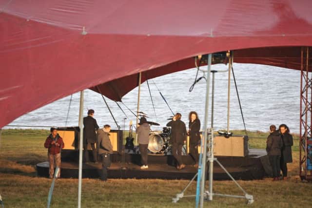 Catfish and the Bottlemen performing under a tent near to Souter Lighthouse.