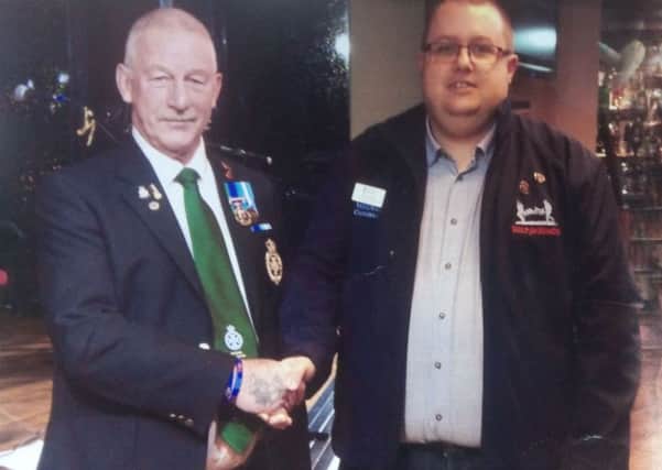 John Houston (L) with representative from Help For Heroes