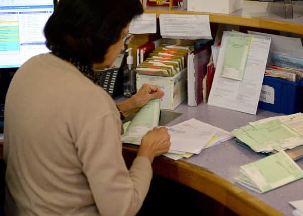 A receptionist sorts prescriptions at a GP practice. Picture by PA Archive/PA Images