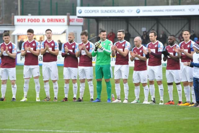 South Shields FC players and supporters take part in a minutes applause in memory of Jak Fada.