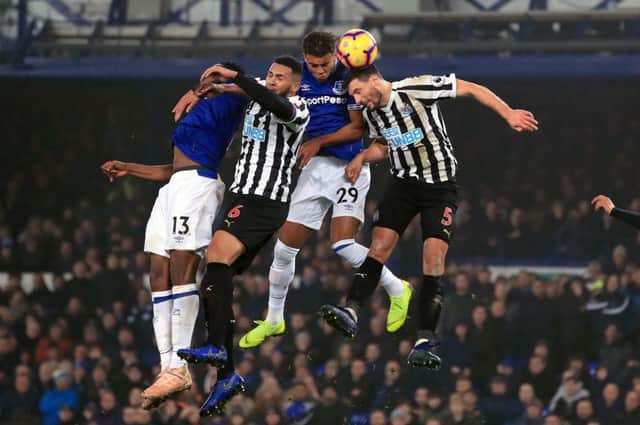 Everton's Yerry Mina (left) and Dominic Calvert-Lewin (second right) battle for the ball with Newcastle United's Jamaal Lascelles (second left) and Fabian Schar (right) during the Premier League match at Goodison Park, Liverpool. PRESS ASSOCIATION Photo. Picture date: Wednesday December 5, 2018. See PA story SOCCER Everton. Photo credit should read: Peter Byrne/PA Wire. RESTRICTIONS: EDITORIAL USE ONLY No use with unauthorised audio, video, data, fixture lists, club/league logos or "live" services. Online in-match use limited to 120 images, no video emulation. No use in betting, games or single club/league/player publications.