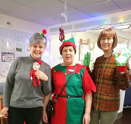 (L-R) Joyce Welsh and Lynda Jones, daughters of resident Joan Welsh, with activities coordinator Amanda Rowden at the Willowdene Care Home Elf Day.