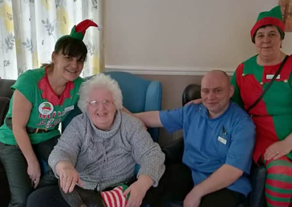 Celebrating Elf Day at Willowdene Care Home are (from left) activities
coordinator Christine Chandler, resident Pat Greig, care assistant Marc Davison and activities coordinator Amanda Rowden.