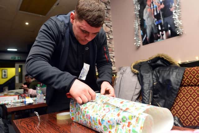 Wrap for Jak, Christmas legacy in memory of younster Jak Fada. Father Tony Fada starts the wrapping event
