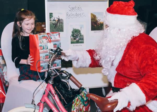 Imogen Carr receiving her bike from Santa.
