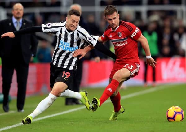 Newcastle United's Javier Manquillo (left) and Fulham's Joe Bryan battle for the ball during the Premier League match at St James' Park, Newcastle. PRESS ASSOCIATION Photo. Picture date: Saturday December 22, 2018. See PA story SOCCER Newcastle. Photo credit should read: Owen Humphreys/PA Wire. RESTRICTIONS: EDITORIAL USE ONLY No use with unauthorised audio, video, data, fixture lists, club/league logos or "live" services. Online in-match use limited to 120 images, no video emulation. No use in betting, games or single club/league/player publications.