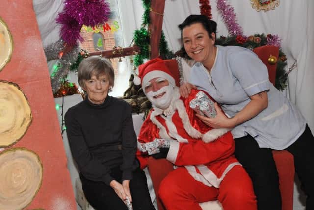 Meadow Care Home resident Carol Herron, left, and activities co-ordinator Julie Carr, right, meet Santa.