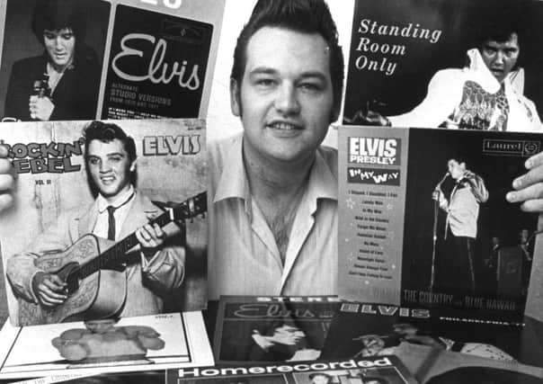 Trevor Cajiao with some of his Elvis records.