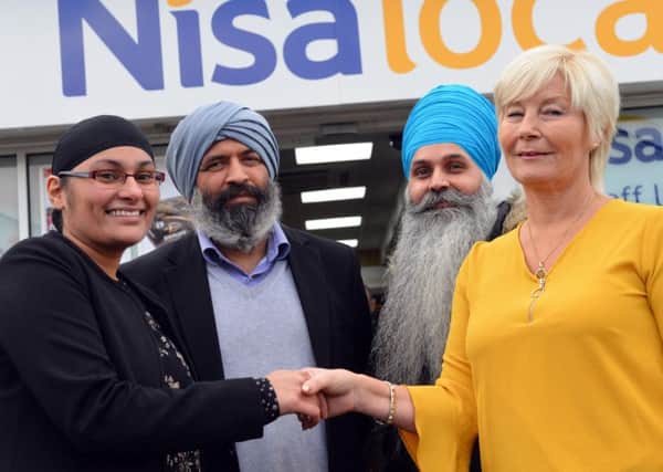 Cancer Connections Deborah Roberts receives donations from Nisa Whiteleas owners Mick Singh and Happy Kaur, who are with friend and charity supporter Tony Singh.