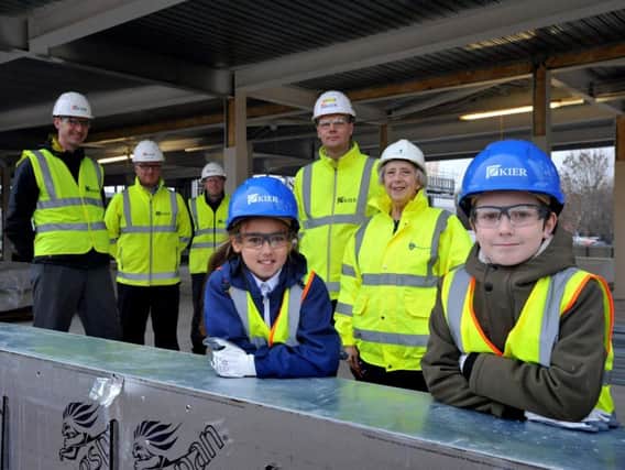 Headteacher Michael Arthur, Kier construction project manager Darran Snarr, contracts manager Steven Lynn, site manager Rhys Brown and Cllr Moira Smith with pupils Katie Barker, and Corey Joyce.