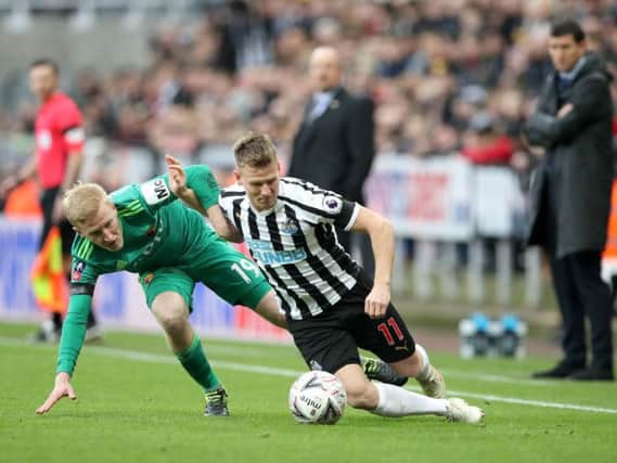 Newcastle's Matt Ritchie challenges for the ball against Watford.