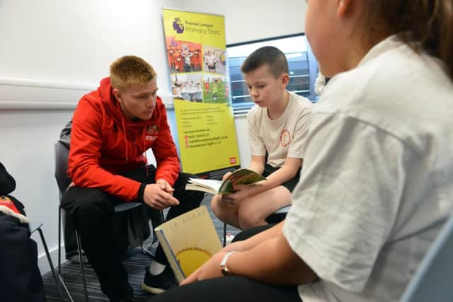 SAFC player Duncan Watmore with pupils from  Jarrow Cross C of E Primary School  as part of National Storytelling Week