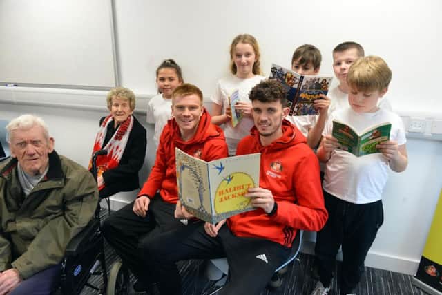 SAFC players Duncan Watmore and Tom Flanagan vists the Beacon of Light as part of National Storytelling Week with Jarrow Cross C of E Primary School pupils and care home residents