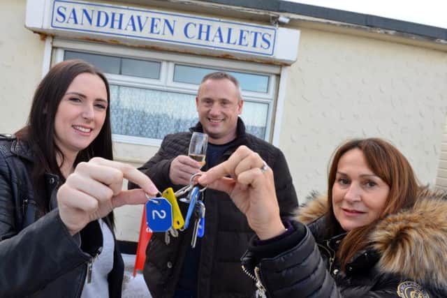 New owners Carleigh McCleod and Tom Cram take over Sandhaven Chalets with former owner Melanie Taylor (R)