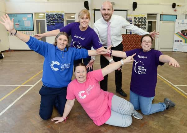 (Back left to right) Ann Walsh (event organiser and teacher), Tracy Pye (teacher and cancer survivor), Chris Rue (headteacher) and Lily Slater (year 10 pupil and cancer survivor) with Rachel Speight-McGregor (local fundraising manager for Cancer Research UK) after taking part in the Zumba for World Cancer event held at Epinay School. Picture by FRANK REID