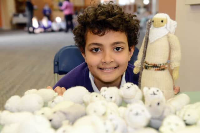 Cleadon Church of England Academy charter school pupil Joshua Markqick with the shepherd and his flock as part of the Knitted Bible.